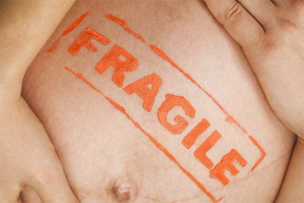 image of a baby's belly with the word fragile in red