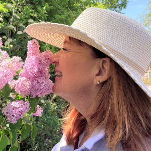 Dr. Erin smelling purple flowers