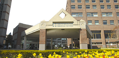 exterior of medical building with yellow flowers